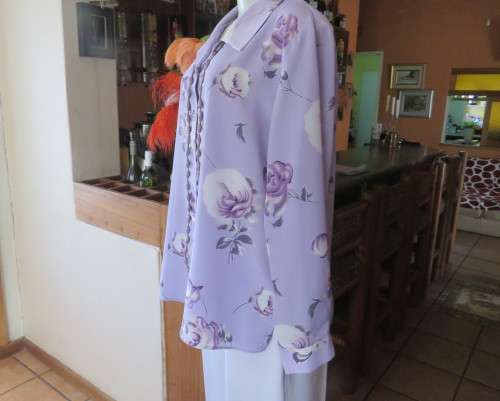 Lavender long sleeve blouse with button down front. Bold purple/white flowers.Size 42 by AREZZO.