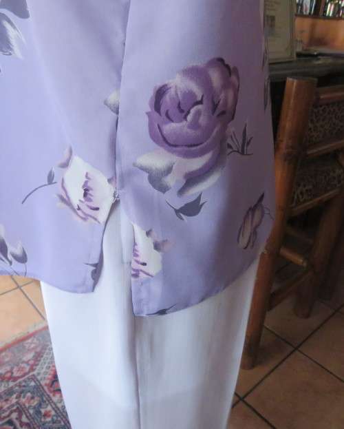 Lavender long sleeve blouse with button down front. Bold purple/white flowers.Size 42 by AREZZO.