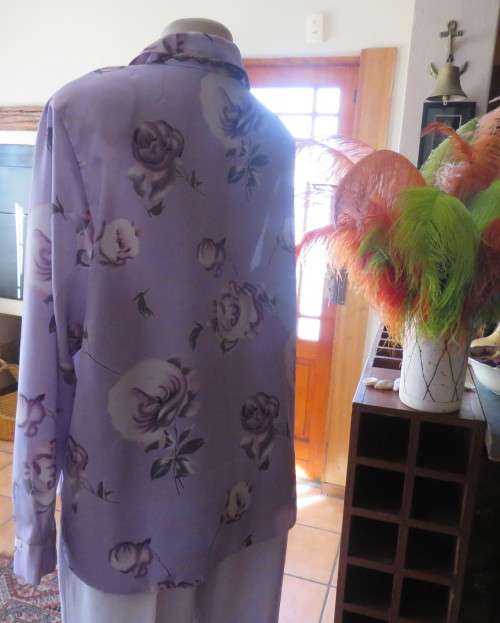 Lavender long sleeve blouse with button down front. Bold purple/white flowers.Size 42 by AREZZO.