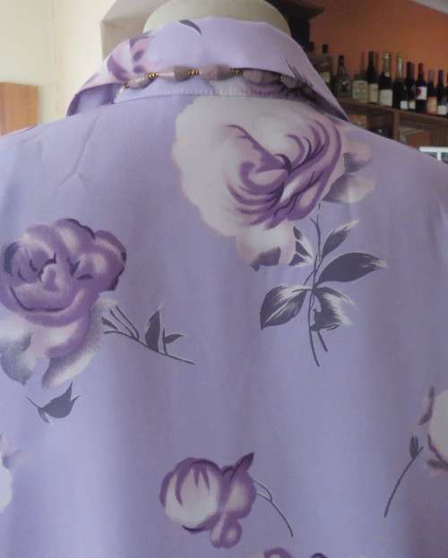 Lavender long sleeve blouse with button down front. Bold purple/white flowers.Size 42 by AREZZO.