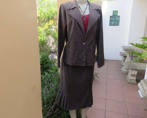 Light weight 2 pc smoke grey skirt suite.Long sleeve 1 button jacket/bandless skirt size 38.As new.