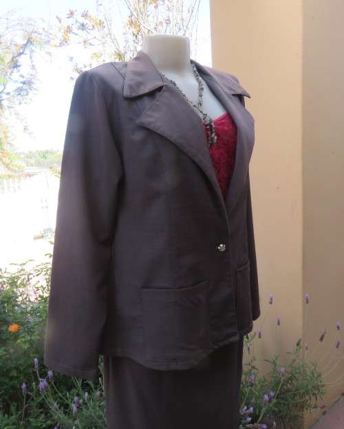Light weight 2 pc smoke grey skirt suite.Long sleeve 1 button jacket/bandless skirt size 38.As new.