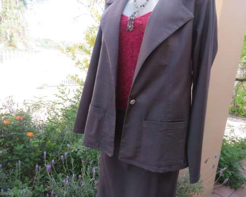 Light weight 2 pc smoke grey skirt suite.Long sleeve 1 button jacket/bandless skirt size 38.As new.