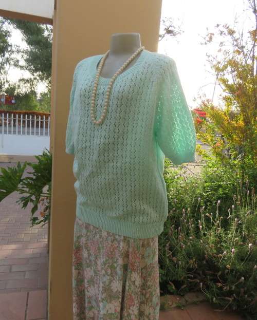 Beautiful handknitted mint green slip over top.Short raglan sleeves.Lace stitch front.Size 44 to 46.