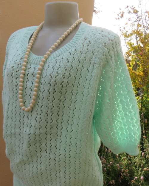 Beautiful handknitted mint green slip over top.Short raglan sleeves.Lace stitch front.Size 44 to 46.