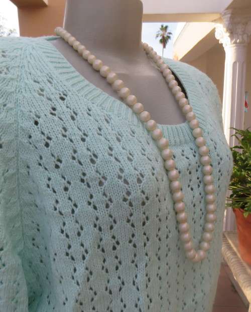 Beautiful handknitted mint green slip over top.Short raglan sleeves.Lace stitch front.Size 44 to 46.