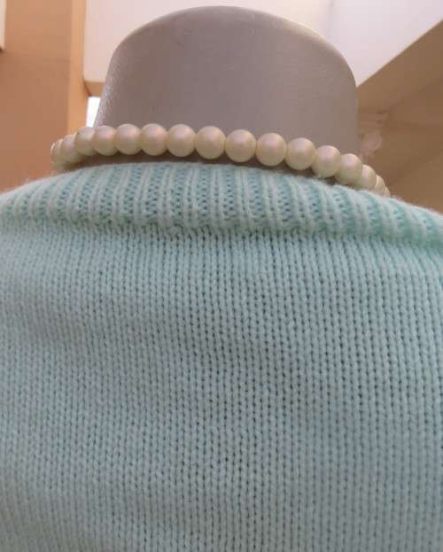 Beautiful handknitted mint green slip over top.Short raglan sleeves.Lace stitch front.Size 44 to 46.