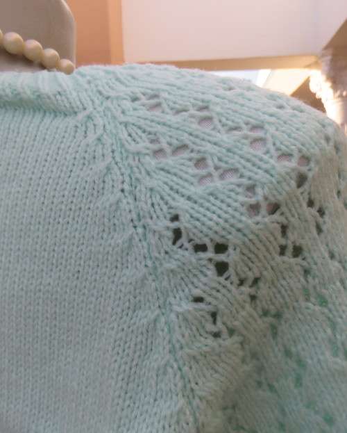 Beautiful handknitted mint green slip over top.Short raglan sleeves.Lace stitch front.Size 44 to 46.
