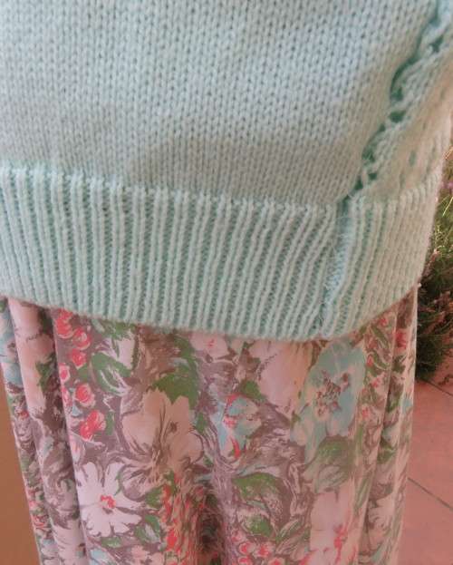 Beautiful handknitted mint green slip over top.Short raglan sleeves.Lace stitch front.Size 44 to 46.