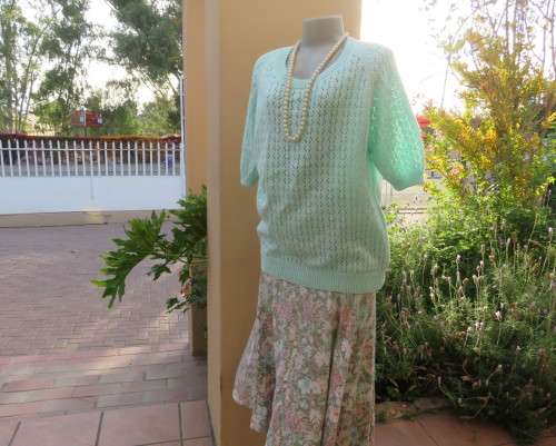 Beautiful handknitted mint green slip over top.Short raglan sleeves.Lace stitch front.Size 44 to 46.