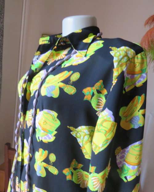 Eyecatching black long sleeve button down blouse with yellow/orange designs.Size 42/18 by B&W.As new