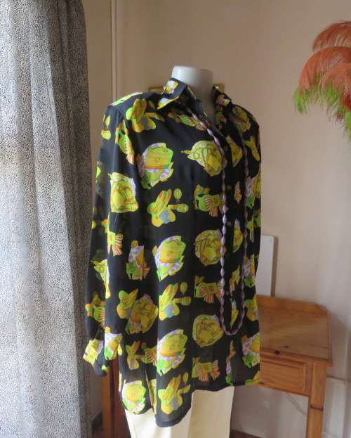 Eyecatching black long sleeve button down blouse with yellow/orange designs.Size 42/18 by B&W.As new
