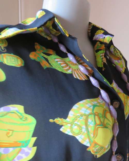 Eyecatching black long sleeve button down blouse with yellow/orange designs.Size 42/18 by B&W.As new