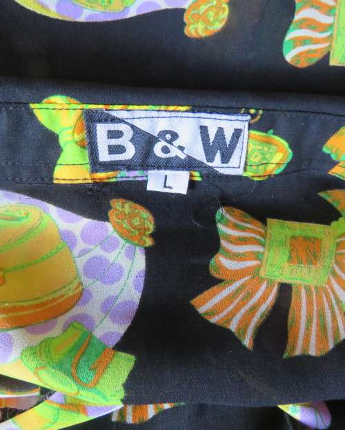 Eyecatching black long sleeve button down blouse with yellow/orange designs.Size 42/18 by B&W.As new