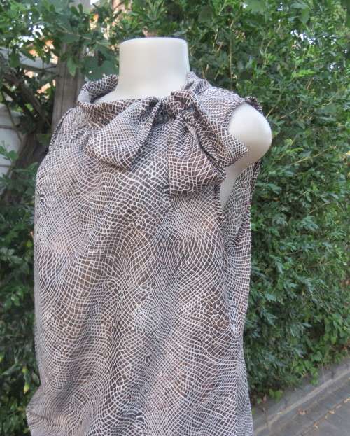 Chic brown/white animal print sleeveless slip over polyester top. Wide banded collar to tie. Size 38