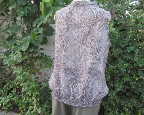 Chic brown/white animal print sleeveless slip over polyester top. Wide banded collar to tie. Size 38