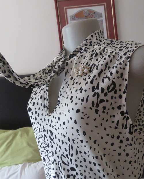 Fabulous slip over silky poly cream/black animal print  top.Size 36 by STUDIO W..Tie collar.