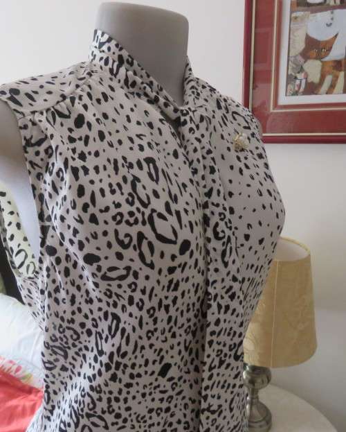 Fabulous slip over silky poly cream/black animal print  top.Size 36 by STUDIO W..Tie collar.
