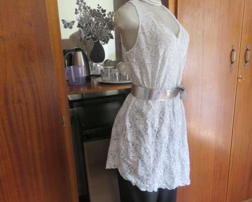 Pretty white/silver floral stretch acrylic lace asymmetrical top size 40/16.V neckline.As new.