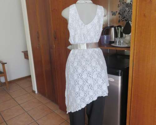 Pretty white/silver floral stretch acrylic lace asymmetrical top size 40/16.V neckline.As new.