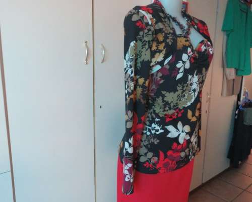 Black stretch polyester background with red,purple and gold floral pattern top.Tiny bolero.Size 38