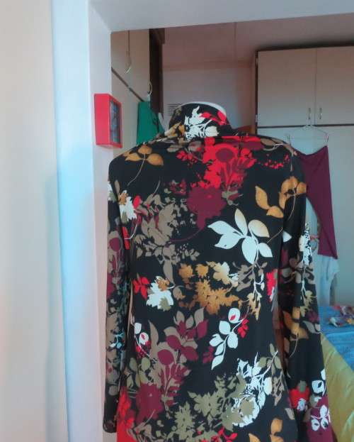 Black stretch polyester background with red,purple and gold floral pattern top.Tiny bolero.Size 38