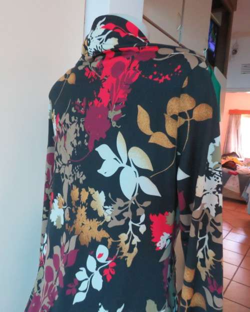 Black stretch polyester background with red,purple and gold floral pattern top.Tiny bolero.Size 38
