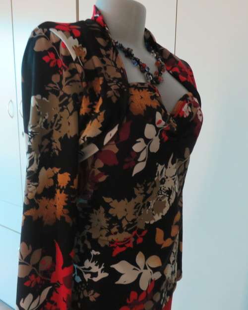 Black stretch polyester background with red,purple and gold floral pattern top.Tiny bolero.Size 38