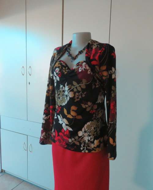 Black stretch polyester background with red,purple and gold floral pattern top.Tiny bolero.Size 38