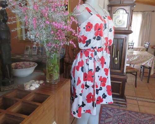 Cool cream strappy dress with red/black bold flowers.In soft polyester.Size 38.As new cond.