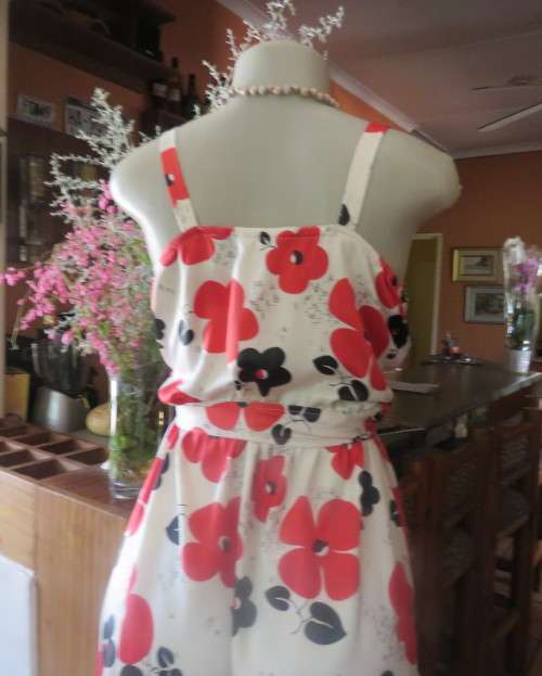 Cool cream strappy dress with red/black bold flowers.In soft polyester.Size 38.As new cond.