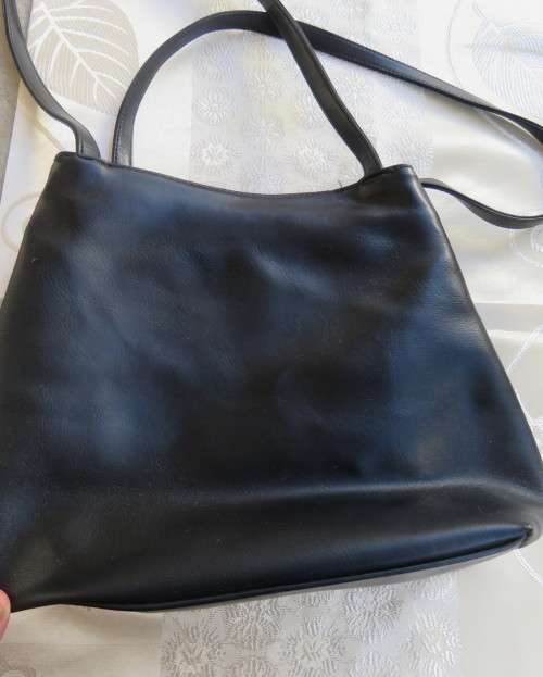 Fabulous soft black faux leather shoulder bag.3 divisions.Zip-ups + press button.26cm x 32cm.As new