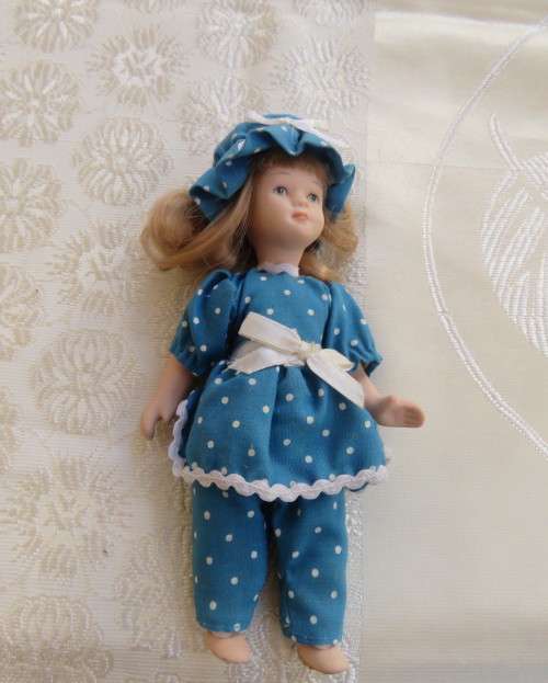 Antique doll 16cm tall with clothing. See all scans. In very good condition