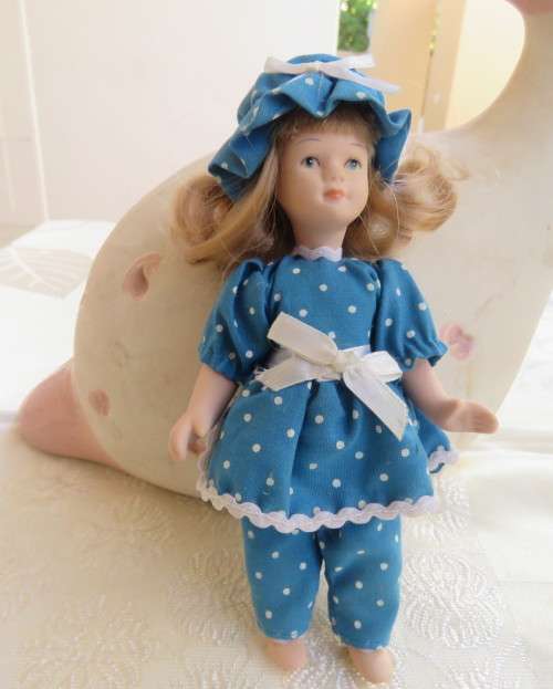 Antique doll 16cm tall with clothing. See all scans. In very good condition