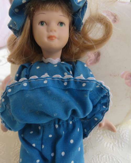 Antique doll 16cm tall with clothing. See all scans. In very good condition