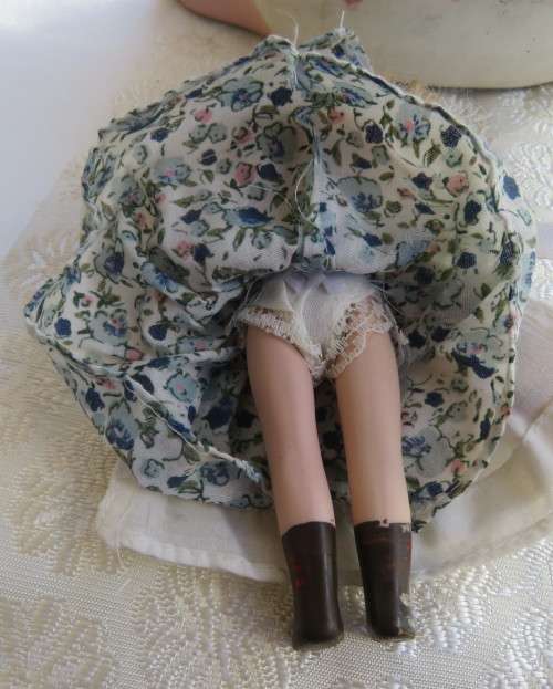 Antique doll 16cm tall with clothing. See scans. Very good condition