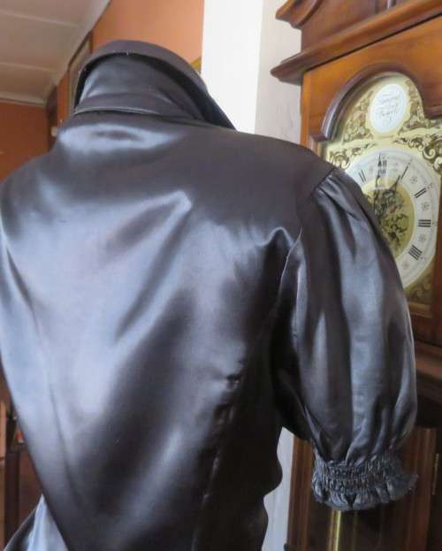 As new black shiny/stretch satin/polyester button down top.V and collar.Empire front.OASIS 34