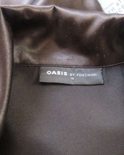 As new black shiny/stretch satin/polyester button down top.V and collar.Empire front.OASIS 34