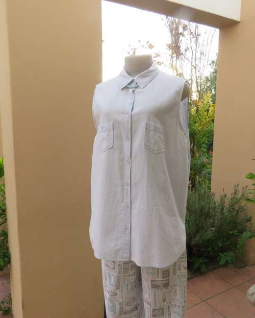 Cool pale blue sleeveless bubble cotton top with button down front.Size 40 to 42.Two cute pockets.