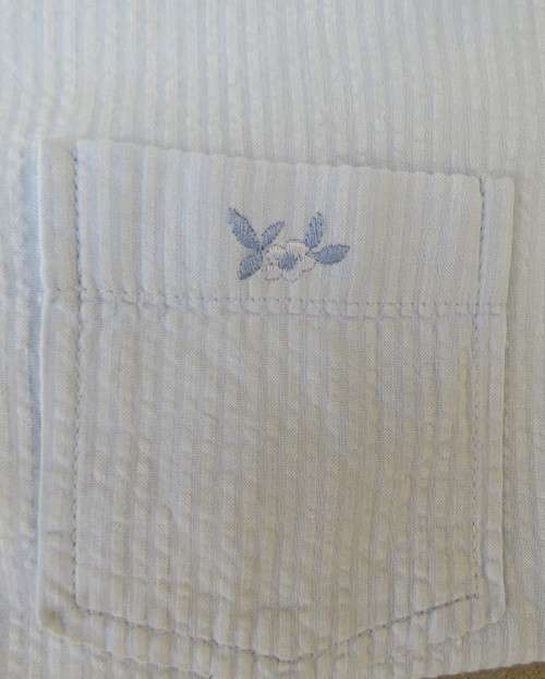 Cool pale blue sleeveless bubble cotton top with button down front.Size 40 to 42.Two cute pockets.