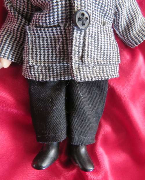 Antique little boy doll in suite with shoes..Movable arms and legs. Length 14cm.