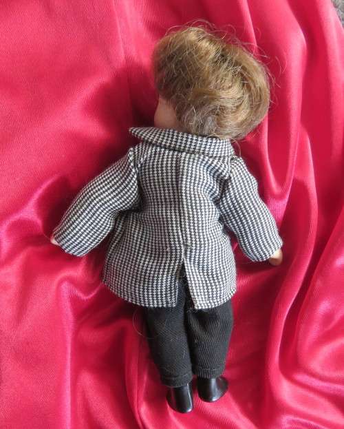 Antique little boy doll in suite with shoes..Movable arms and legs. Length 14cm.