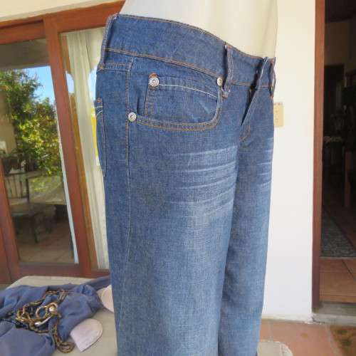 Low rise fashion blue denim jeans. Wide legged. 100% cotton.By RT size 36/12. New condition
