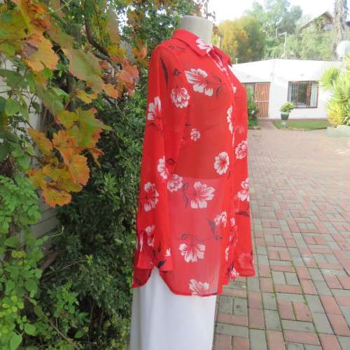 Eye catching red with white floral long top in sheer polyester. Cuffed sleeves. Size 36 by MILADY`S.