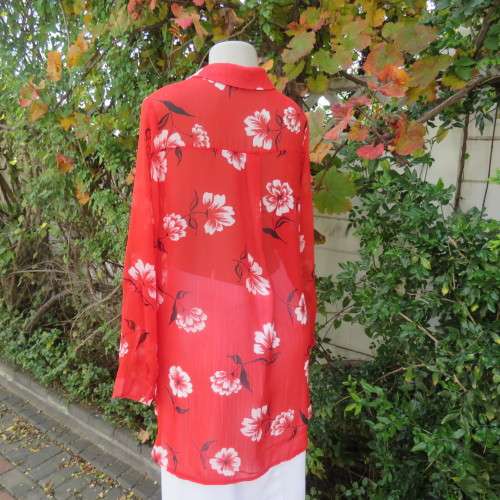 Eye catching red with white floral long top in sheer polyester. Cuffed sleeves. Size 36 by MILADY`S.