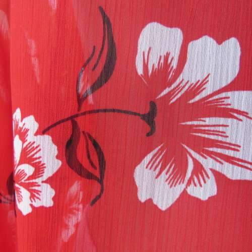 Eye catching red with white floral long top in sheer polyester. Cuffed sleeves. Size 36 by MILADY`S.