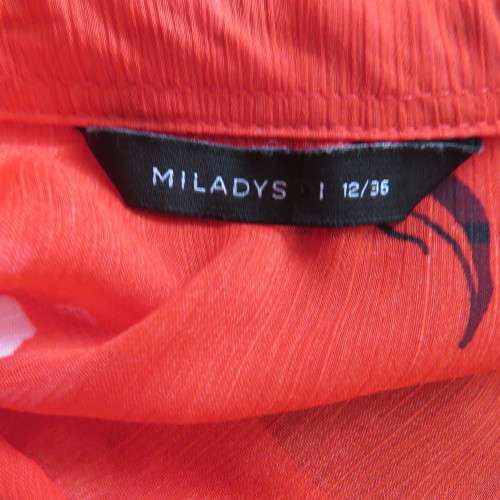 Eye catching red with white floral long top in sheer polyester. Cuffed sleeves. Size 36 by MILADY`S.