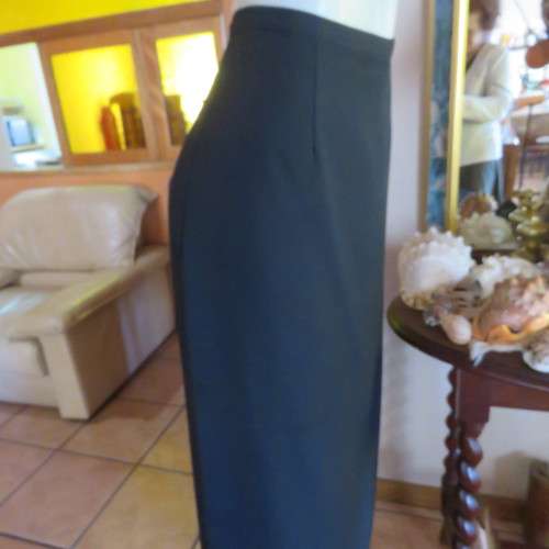 Ankle length black crepe polyester pencil skirt with pleat and zip at back. Size 40/16 by DIANELLO.