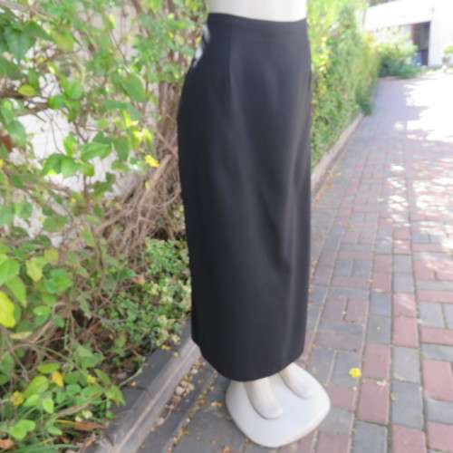Ankle length black crepe polyester pencil skirt with pleat and zip at back. Size 40/16 by DIANELLO.