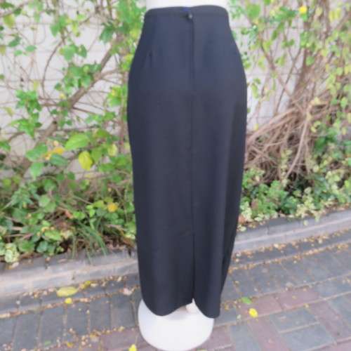 Ankle length black crepe polyester pencil skirt with pleat and zip at back. Size 40/16 by DIANELLO.